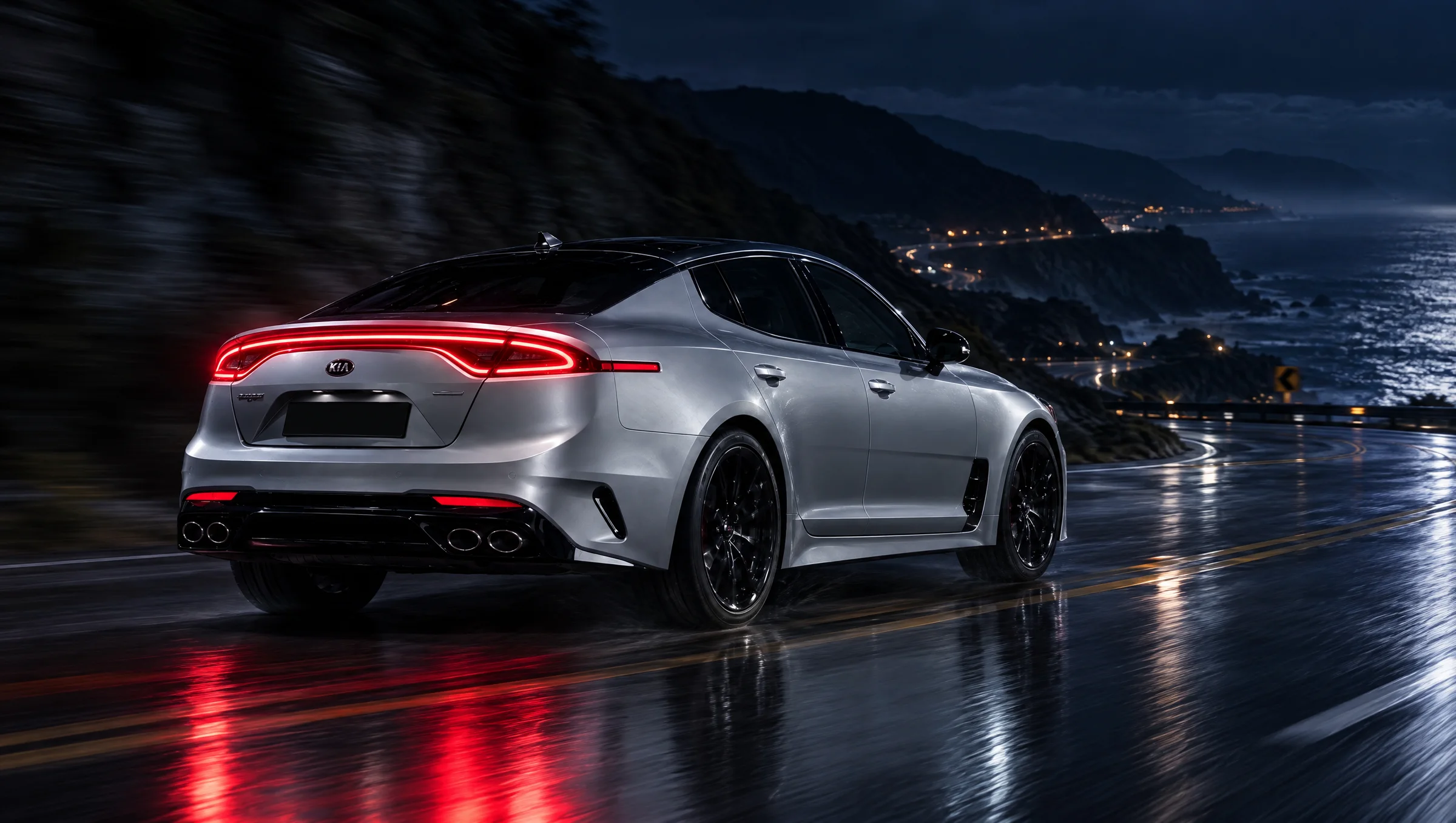 Kia Stinger Tribute Edition on a wet coastal road at night, tail lights glowing