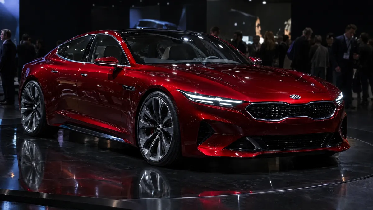 Red four-door concept car on a motor show stand