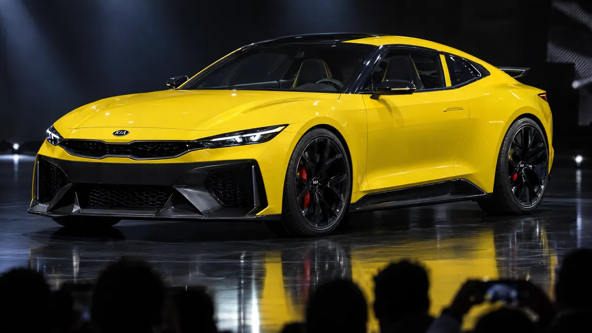 Yellow two-door coupé concept under show lights