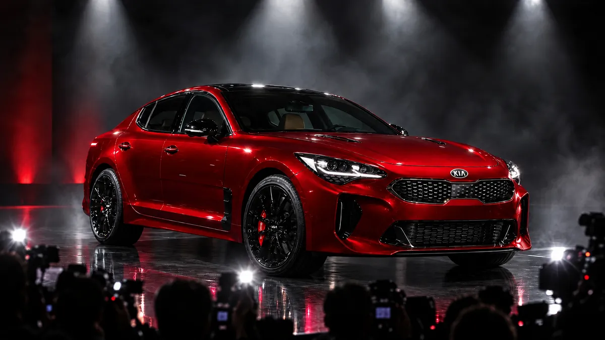 Red Stinger unveiled on a dark stage in front of photographers